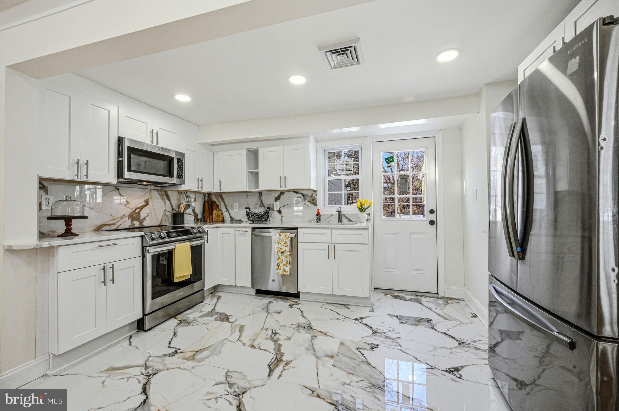 4 Lower Greenbriar Road Wilmington, DE 19810 - Photo 8 of 42 a kitchen with a refrigerator sink and microwave