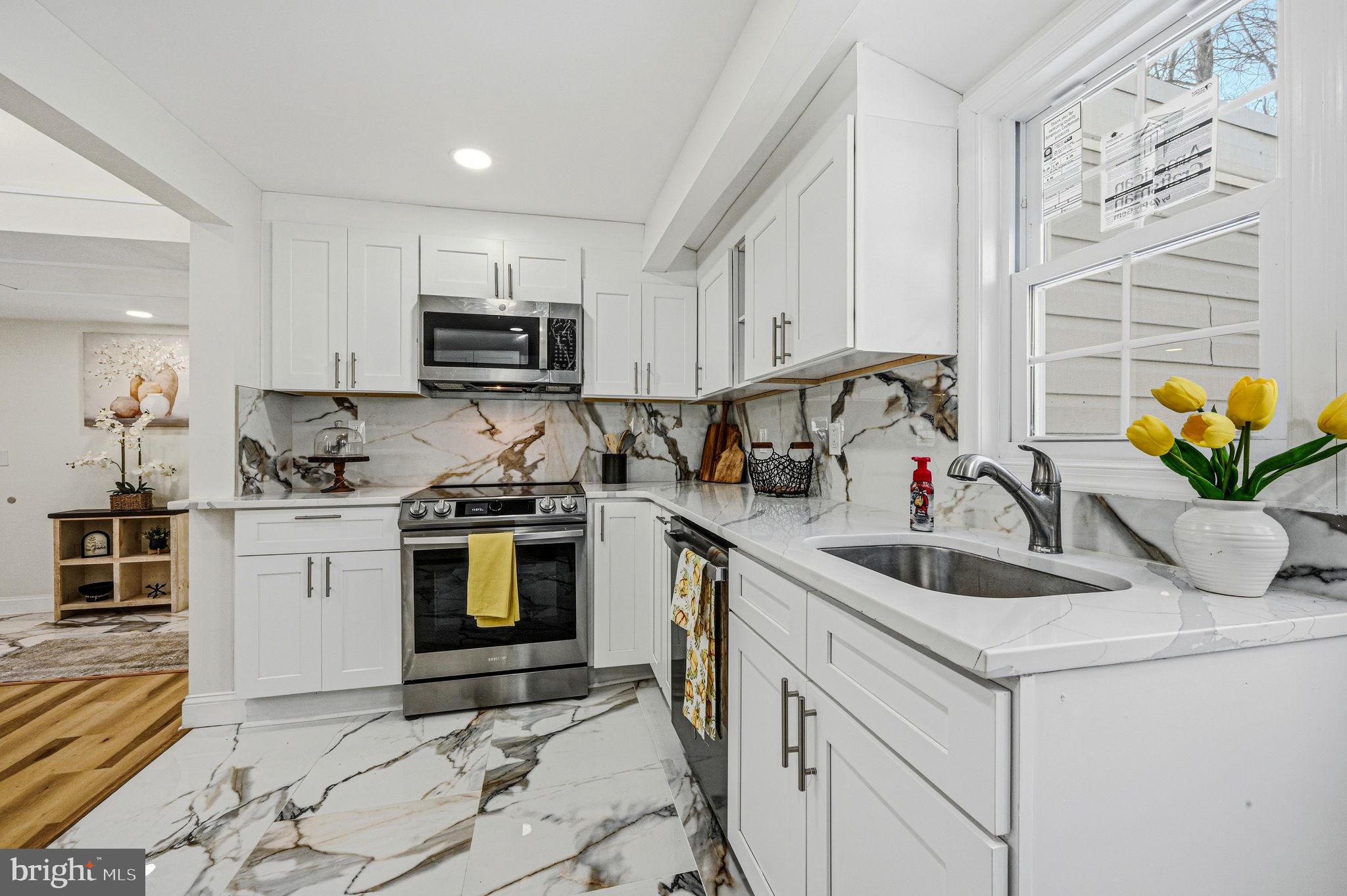 4 Lower Greenbriar Road Wilmington, DE 19810 - Photo 10 of 42 a kitchen with stainless steel appliances granite countertop a sink a stove and a refrigerator