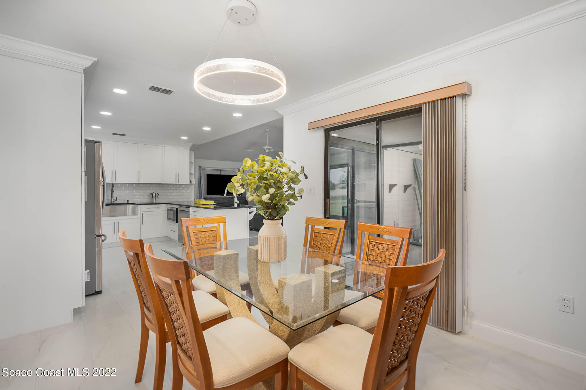 412 Godfrey Road Southeast Palm Bay, FL 32909 - Photo 11 of 22 a dining room with furniture and chandelier
