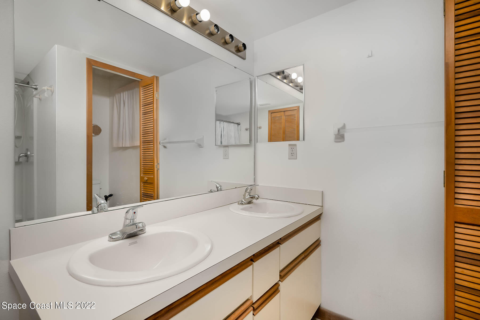 412 Godfrey Road Southeast Palm Bay, FL 32909 - Photo 16 of 22 a bathroom with a sink and a mirror