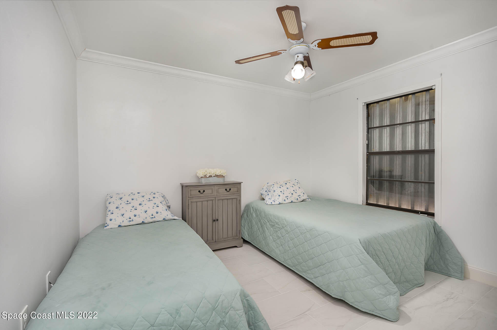 412 Godfrey Road Southeast Palm Bay, FL 32909 - Photo 19 of 22 a bedroom with a bed and a window