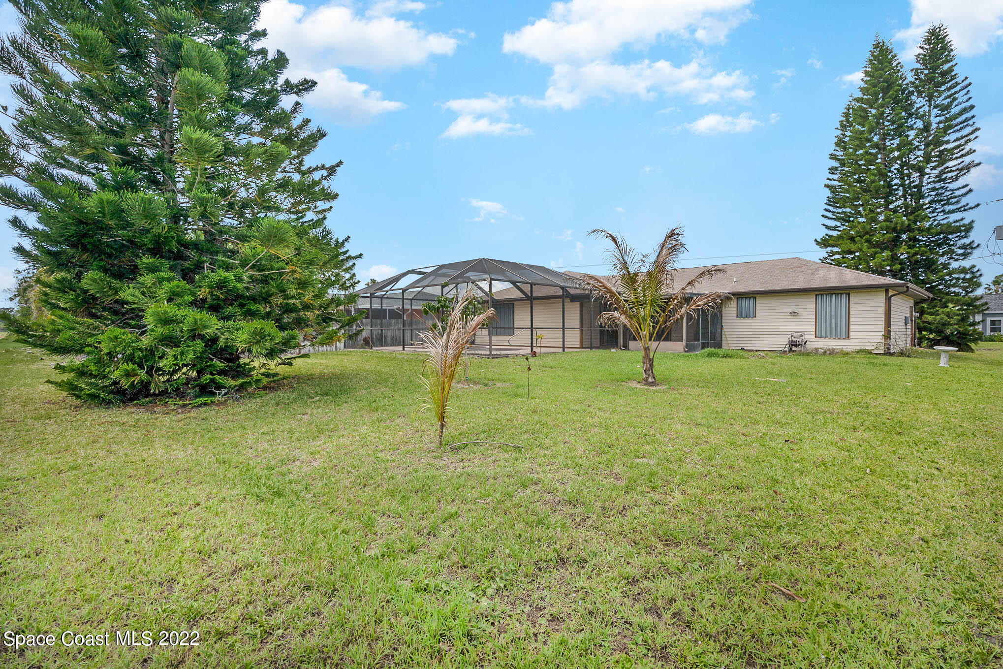 412 Godfrey Road Southeast Palm Bay, FL 32909 - Photo 22 of 22 a house with lots of trees in the background