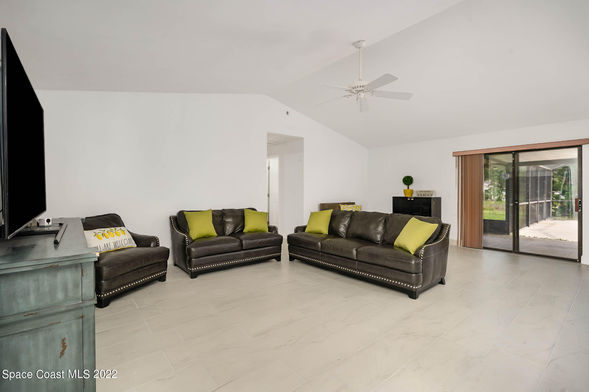 412 Godfrey Road Southeast Palm Bay, FL 32909 - Photo 8 of 22 a living room with furniture and a flat screen tv