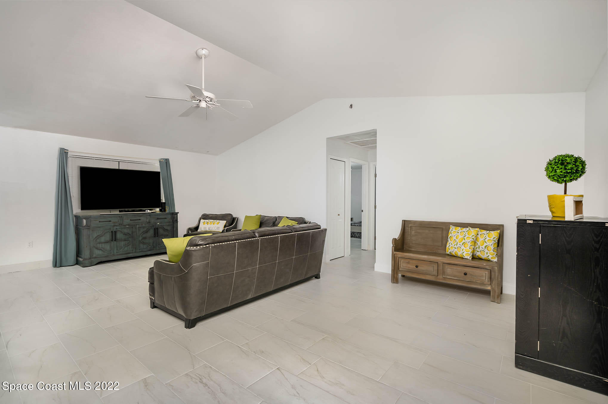 412 Godfrey Road Southeast Palm Bay, FL 32909 - Photo 9 of 22 a living room with furniture and a flat screen tv