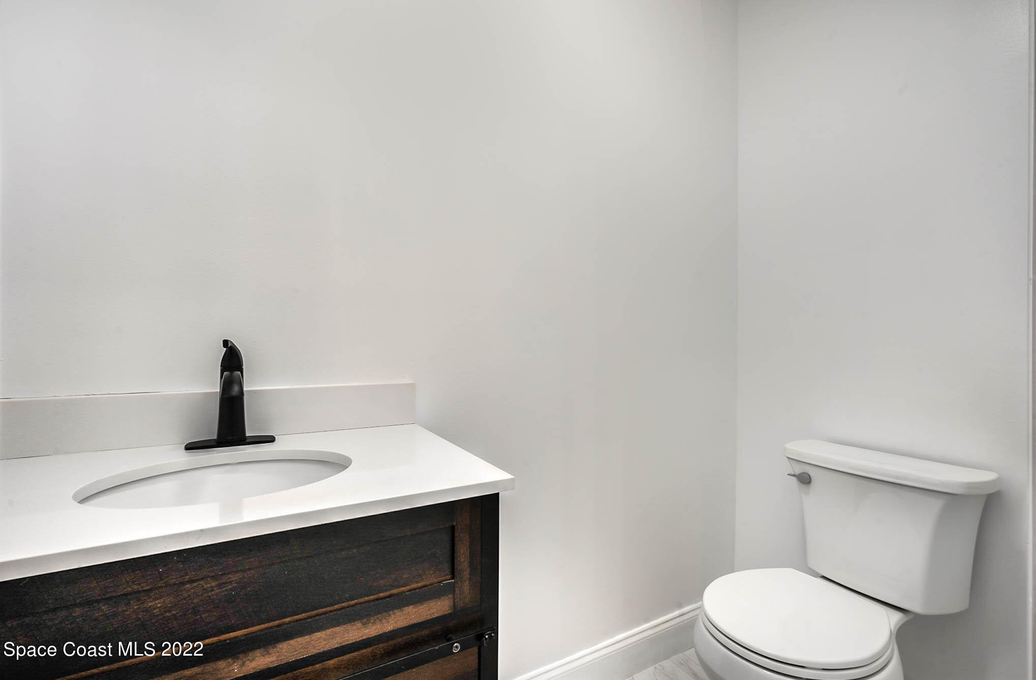 412 Godfrey Road Southeast Palm Bay, FL 32909 - Photo 10 of 22 a bathroom with a sink and a toilet