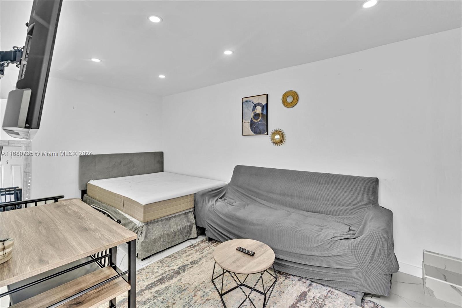 4328 Southwest 49th Court, Unit 2 Dania Beach, FL 33314 - Photo 3 of 18 a living room with furniture and a table