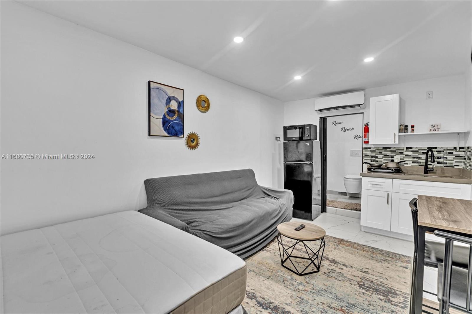 4328 Southwest 49th Court, Unit 2 Dania Beach, FL 33314 - Photo 6 of 18 a living room with furniture and kitchen view