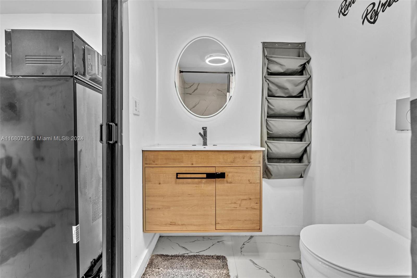 4328 Southwest 49th Court, Unit 2 Dania Beach, FL 33314 - Photo 10 of 18 a bathroom with a toilet a sink and shower