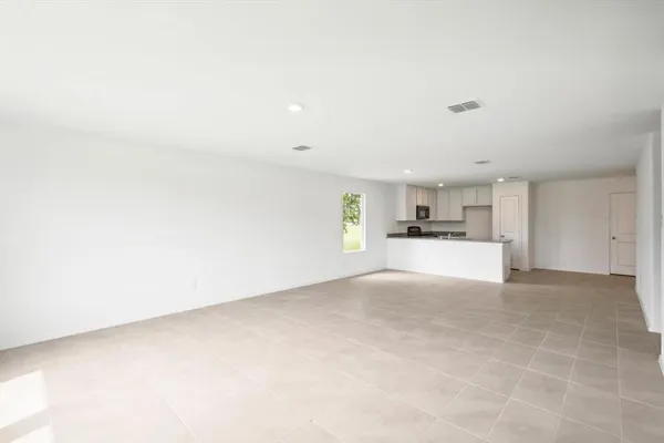 a view of kitchen with refrigerator and window