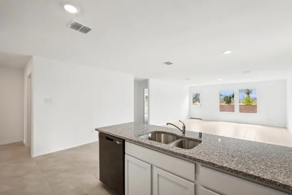 a kitchen with stainless steel appliances granite countertop a sink and a granite counter tops