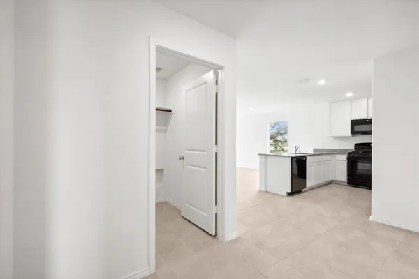 a view of kitchen with refrigerator sink and natural light