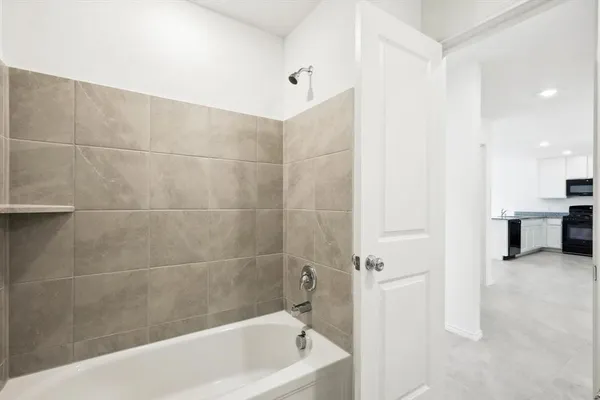 a bathroom with a bathtub and a shower