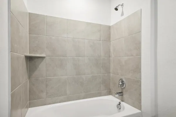 a bath tub sitting next to a white sink and vanity