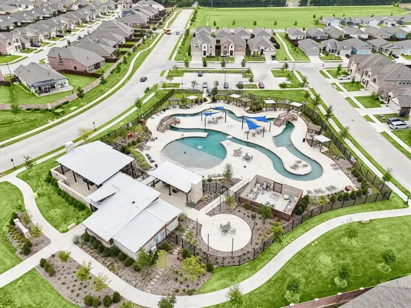 an aerial view of a residential houses with outdoor space