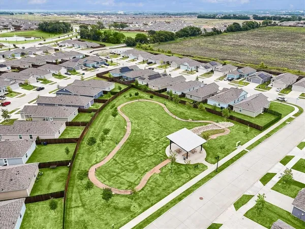 an aerial view of residential houses with outdoor space and river