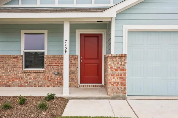 a front view of a house with a red gate