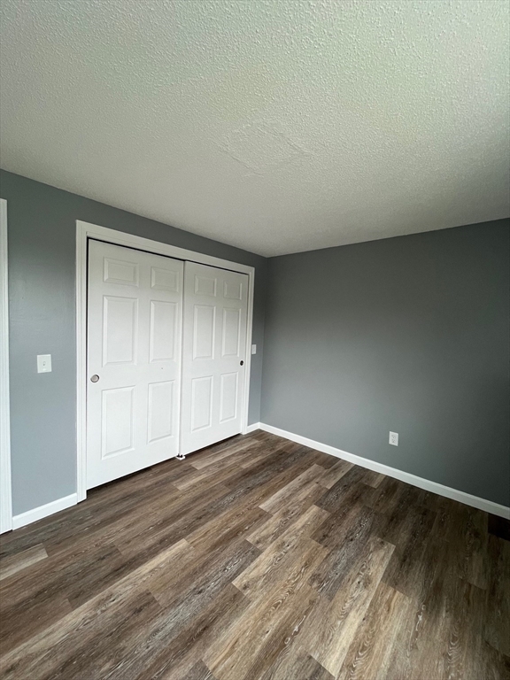 1475 Braley Road, Unit 17 New Bedford, MA 02745 - Photo 7 of 9 a view of an empty room and wooden floor