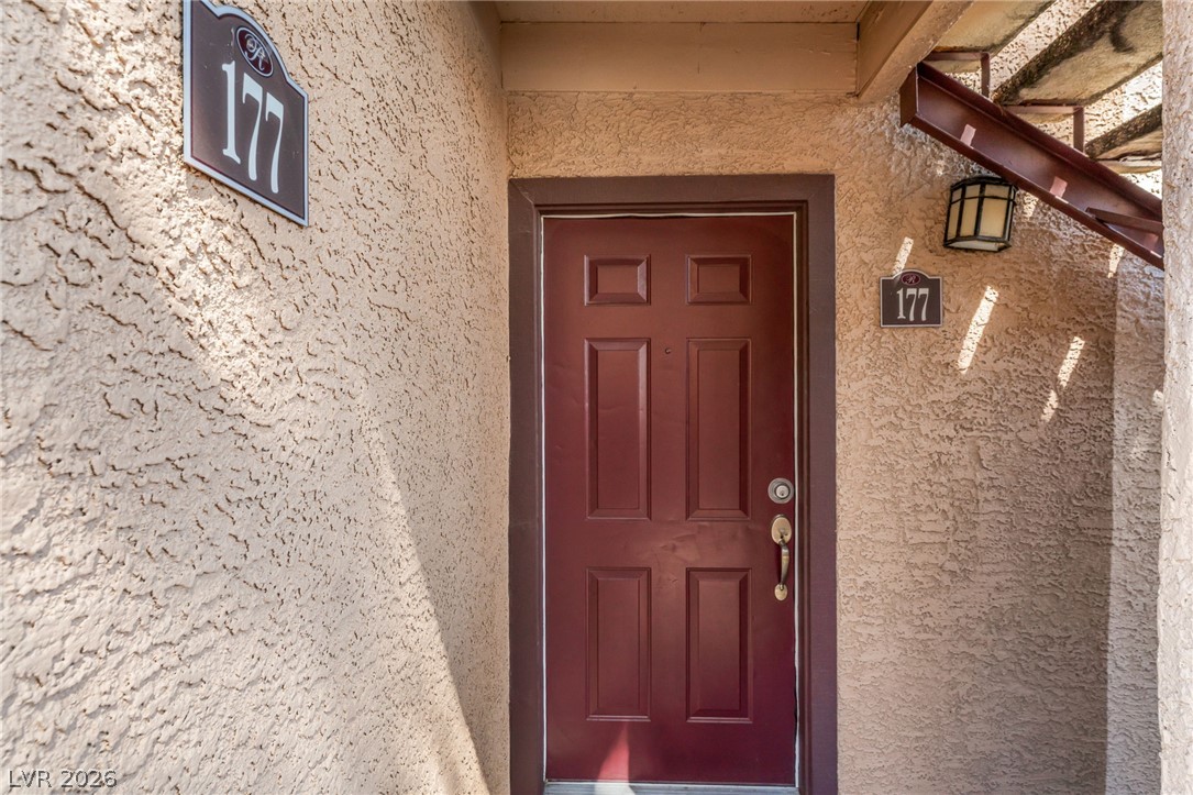 9325 West Desert Inn Road, Unit 177 Las Vegas, NV 89117 - Photo 3 of 24 Stucco textured walls and a sheltered entryway create a welcoming transition into the home.