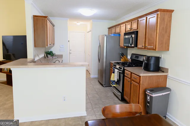 a kitchen with stainless steel appliances granite countertop a sink stove and cabinets