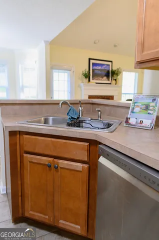a kitchen with granite countertop white cabinets and a potted plant