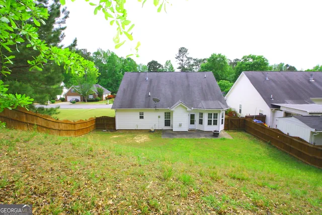 a view of a house with pool and garden