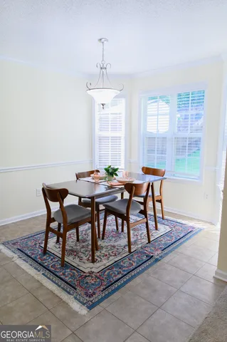 a view of a dining room with furniture window and outside view