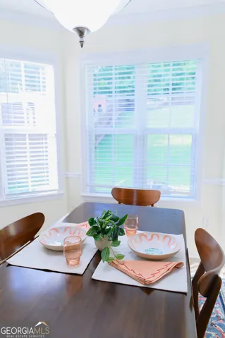 a kitchen with stainless steel appliances a refrigerator a sink a stove and white cabinets