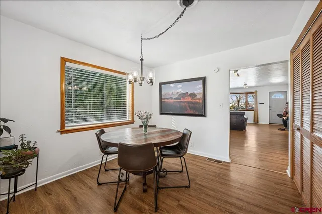 a view of a room with wooden floor and bathroom