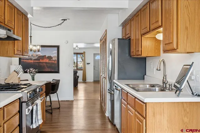 a kitchen with stainless steel appliances granite countertop a refrigerator and a sink