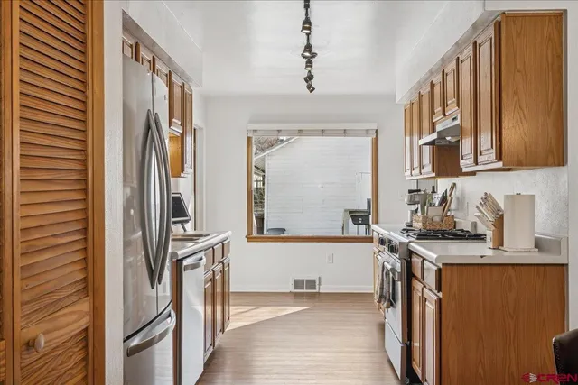 a kitchen with wooden cabinets and sink