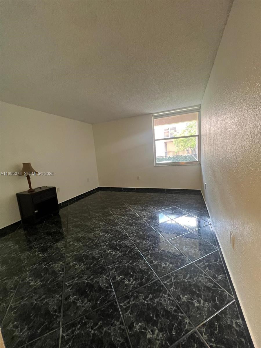 1900 West 68th Street, Unit D207 Hialeah, FL 33014 - Photo 21 of 33 an empty room with a empty space and windows