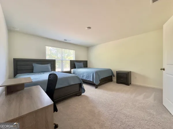 a bedroom with two beds and a couch