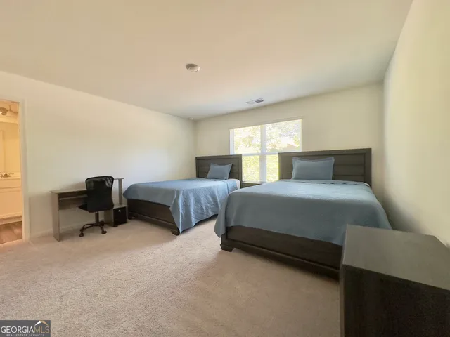 a bedroom with a bed chair and a window