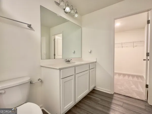 a bathroom with a sink toilet a mirror and shower