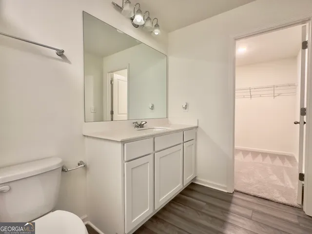 a bathroom with a sink toilet a mirror and shower