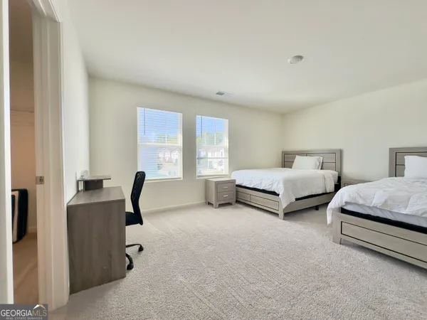 a bedroom with bed and a window