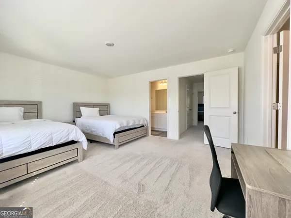 a spacious bedroom with a bed and a closet