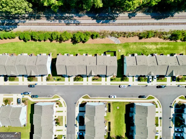 a view of a swimming pool with a lawn chairs under an umbrella