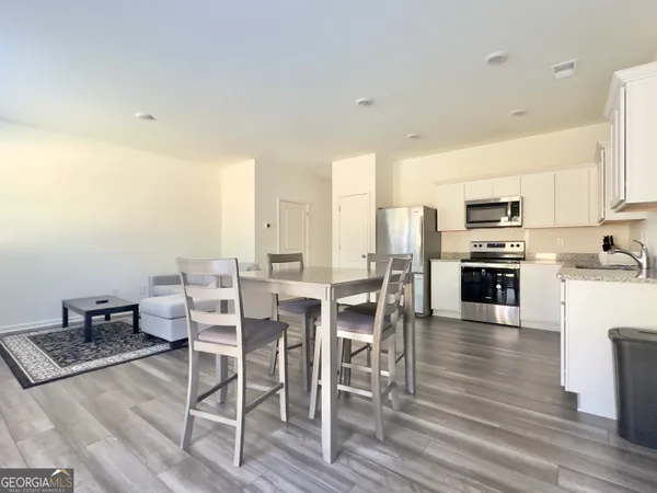 a large kitchen with a table and chairs