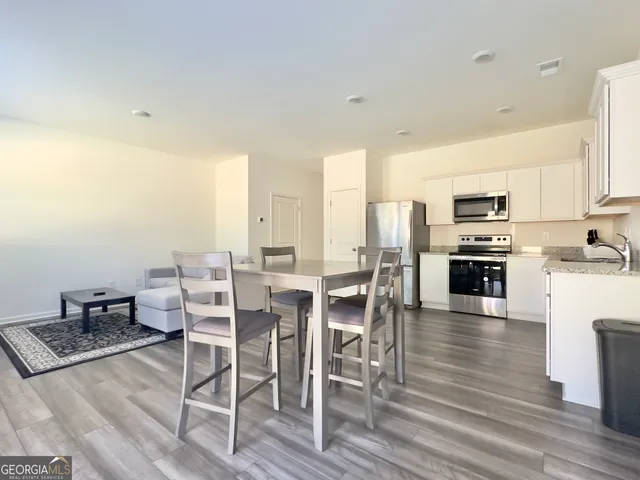 a large kitchen with a table and chairs