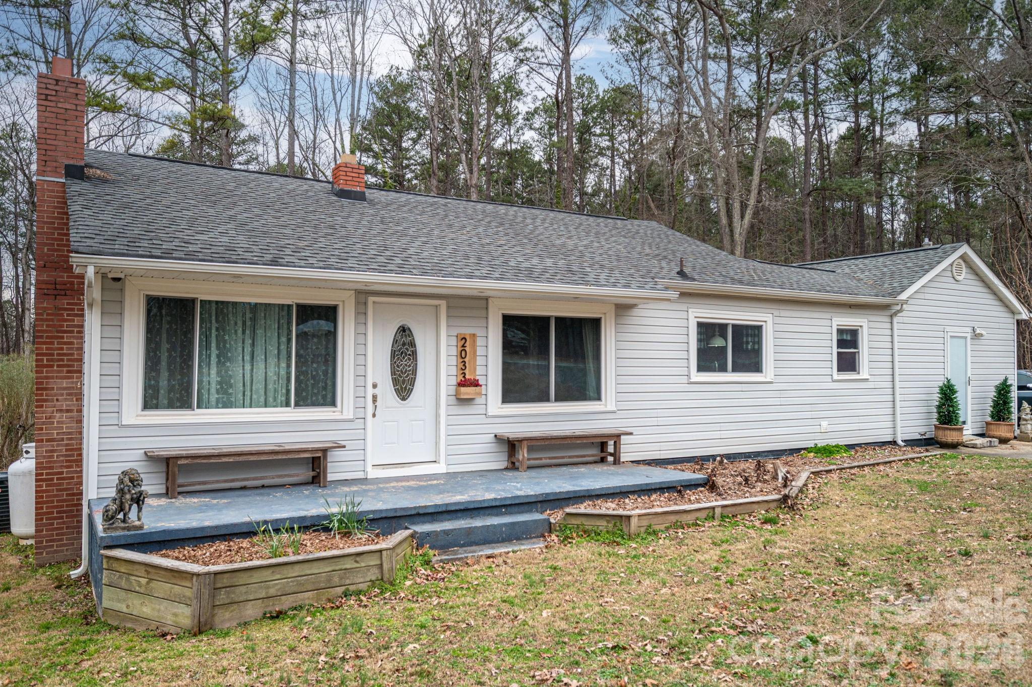 2033 Puetts Chapel Road Bessemer City, NC 28016 - Photo 2 of 38 a view of a house with pool and chairs