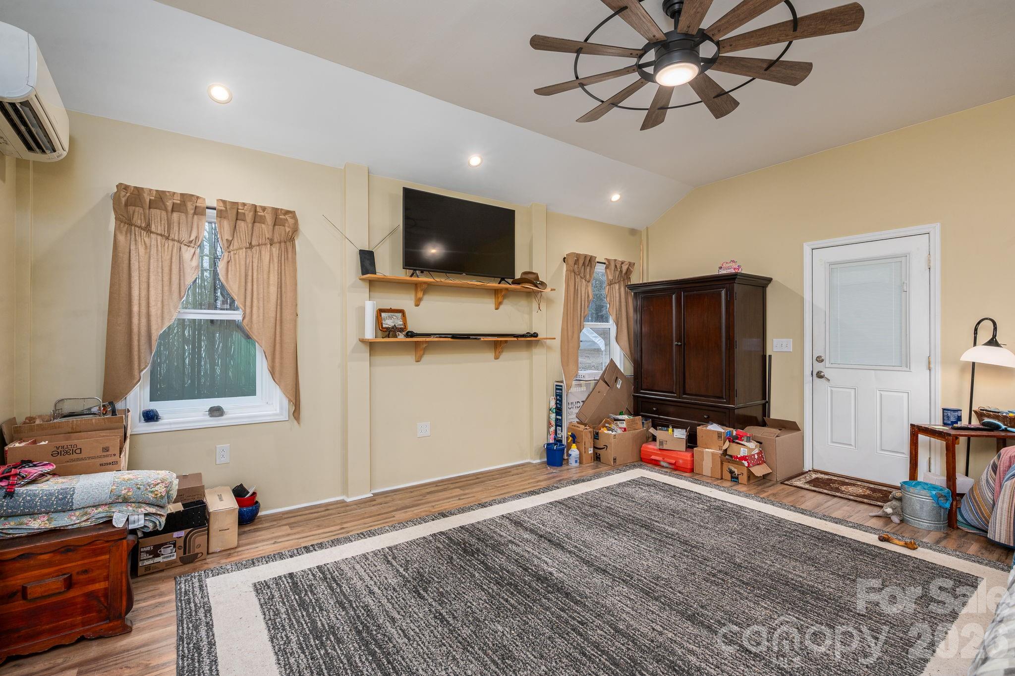2033 Puetts Chapel Road Bessemer City, NC 28016 - Photo 23 of 38 a bedroom with furniture and a flat screen tv