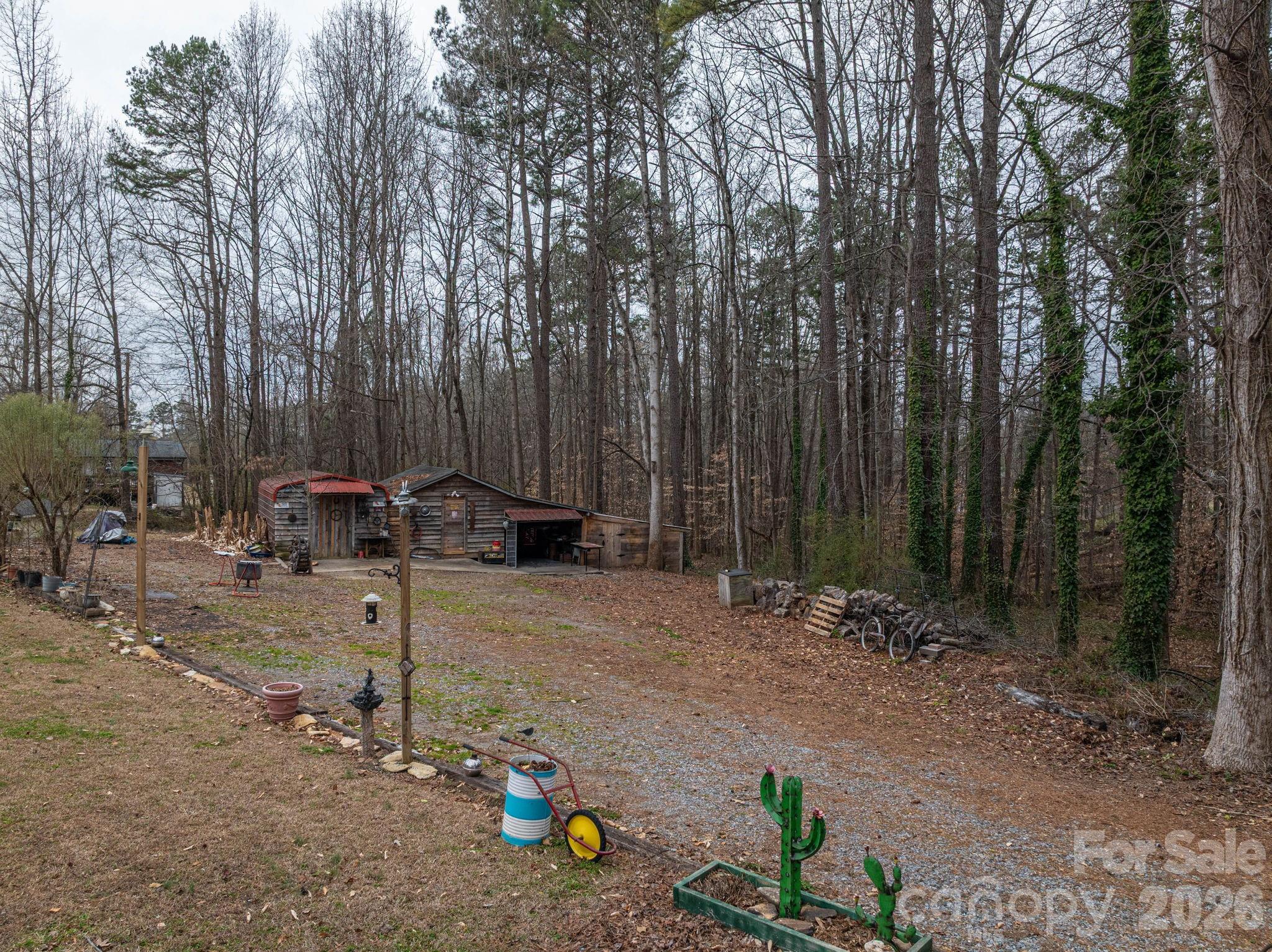 2033 Puetts Chapel Road Bessemer City, NC 28016 - Photo 35 of 38 a view of backyard with a table and chairs