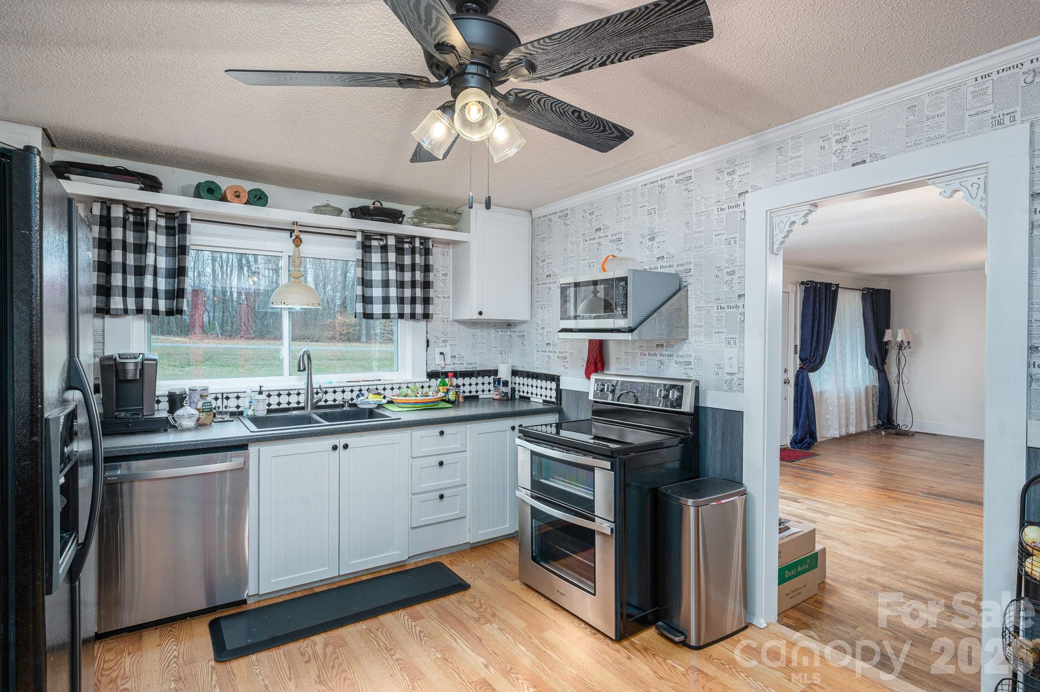 2033 Puetts Chapel Road Bessemer City, NC 28016 - Photo 5 of 38 a kitchen with stainless steel appliances granite countertop a stove sink and cabinets
