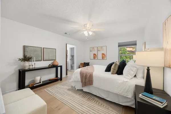 a spacious bedroom with a bed and window