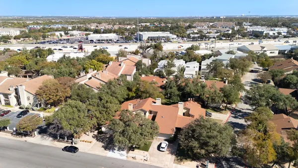 an aerial view of residential houses with outdoor space