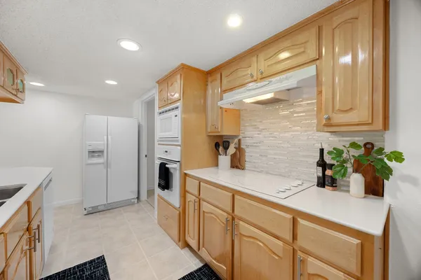 a kitchen with stainless steel appliances granite countertop a sink and cabinets