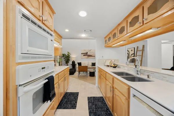 a kitchen with stainless steel appliances granite countertop a sink and a cabinets