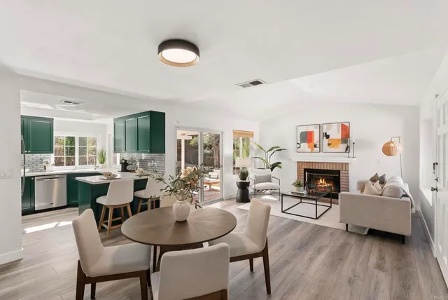 a living room with furniture a fireplace and a table