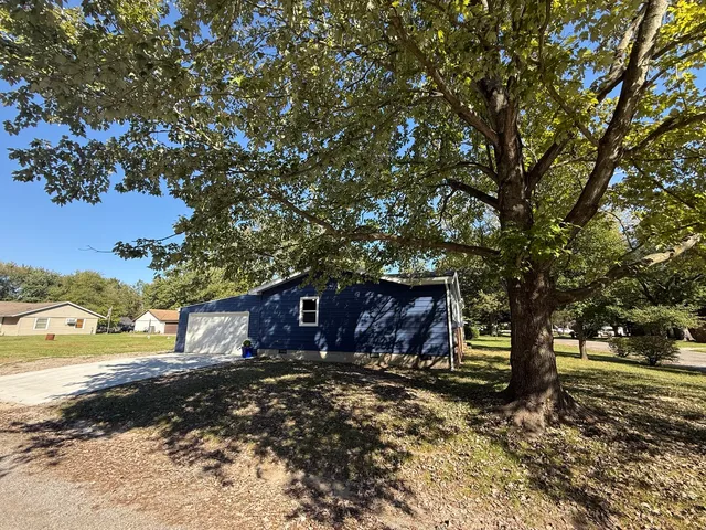 a view of house with outdoor space and sitting area